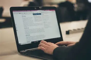 a person doing work on a laptop